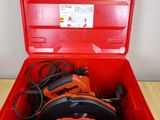 an open red tool box with tools in it sitting on a table