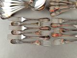 a lot of spoons and forks that are on the table