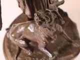 bronze statue of a bird and a dog on a pedestal