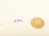 an image of a gold coin sitting on top of a piece of paper
