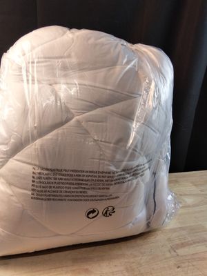 a pillow that is wrapped in plastic on a table