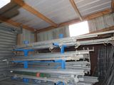 a lot of steel pipes stacked up in a room