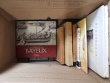 de nombreux livres dans une boîte en carton posée sur une étagère