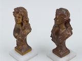 pair of bronze busts of women on marble bases