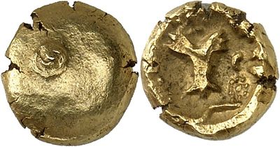 a close up of two gold coins with a tree on them