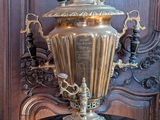 a large brass urn sitting on top of a table