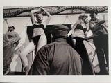 black and white photograph of a group of women in bathing suits on a boat