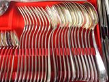 a lot of silverware in a red case
