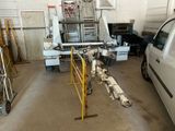 vehicles are parked in a garage with a truck in the background
