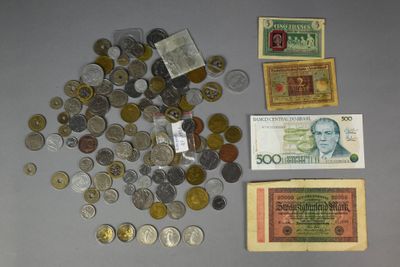 a lot of coins and money sitting on a table