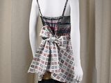 a mannequin wearing a dress with a tie on it