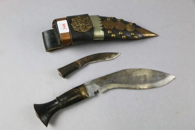 two knives and a knife holder on a table