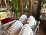 a clear table with a bunch of white plates on it