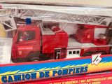 a red toy fire truck with a ladder and a box