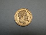 a close up of a gold coin with a man ' s face on it