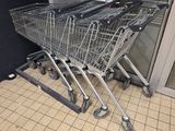 several shopping carts are lined up in a row outside a store