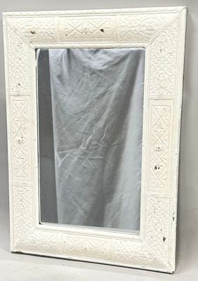 an image of a white framed mirror sitting on top of a table