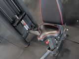a gym room with a row of machines and other equipment