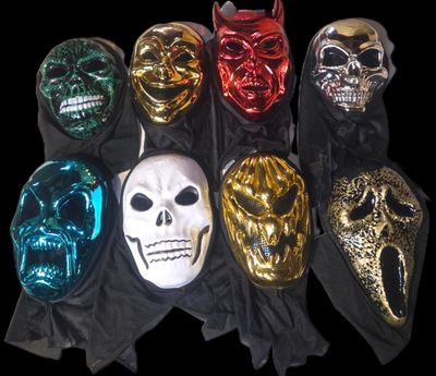 several different colored masks are lined up on a black cloth