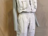 an image of a mannequin dressed in a white jumpsuit on a mannequin stand