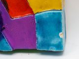 a close up of a colorful object on a white surface