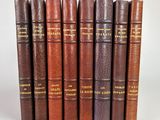 a set of six books with leather covers and gold lettering