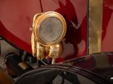 a close up of a red car with gold trims