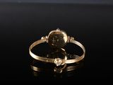 a close up of a gold ring with a diamond on it
