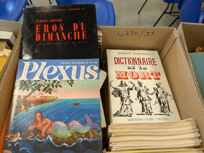 several books are stacked on top of each other in a box