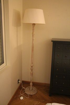une photo d'une chambre avec un lit et une lampe
