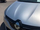 a silver car parked in a parking lot with other cars in the background