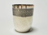 a silver cup that is sitting on a table