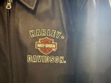 a black leather jacket with a harley davidson logo on it