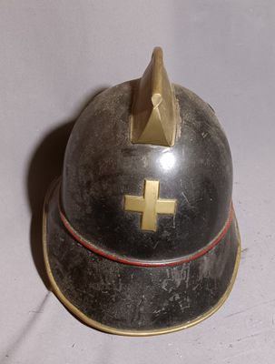 a helmet with a cross on it sitting on a table