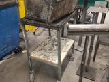 a metal sink sitting on a metal stand in a room