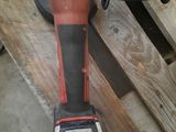 a picture of a corded drill on a wooden table