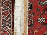a long piece of wood on a rug with a hammer on it