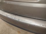 a close up of a car ' s bumper with scratches on it