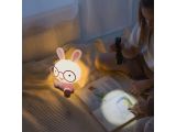 a little girl sitting on a bed reading a book