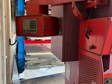 a red machine that is sitting in a building