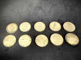 a bunch of gold coins sitting on top of a black surface