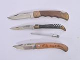 four different types of knives on a white surface