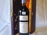 a bottle of wine in a wooden case on a table