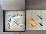 une boîte posée par terre, contenant une maquette d'avion