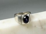 sterling silver ring with a blue sapphire stone in the center