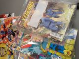 a pile of comic books on a table in a room