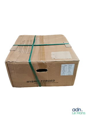 a cardboard box with a green ribbon wrapped around it