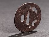 a small coin sitting on a table with a shadow on it