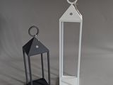 two white lanterns sitting next to each other on a table