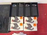several cell phones are sitting on top of a table next to a charger